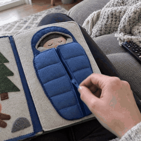 A handmade quiet book zipper page in use